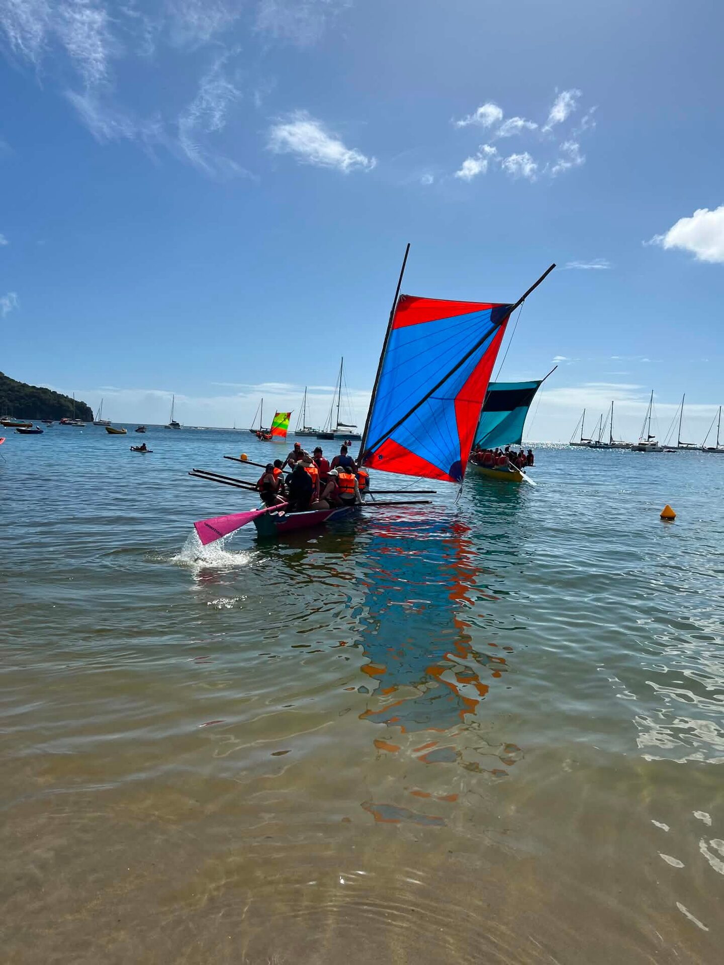Two Martinique yoles with colourful sails racing in the bay of Les Trois-Îlets Two Martinique yoles with colourful sails racing in the bay of Les Trois-Îlets
