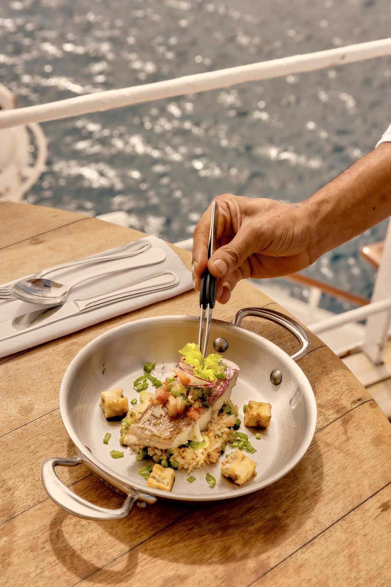 A chef plating a dish on board the Club Med 2 A chef plating a dish on board the Club Med 2