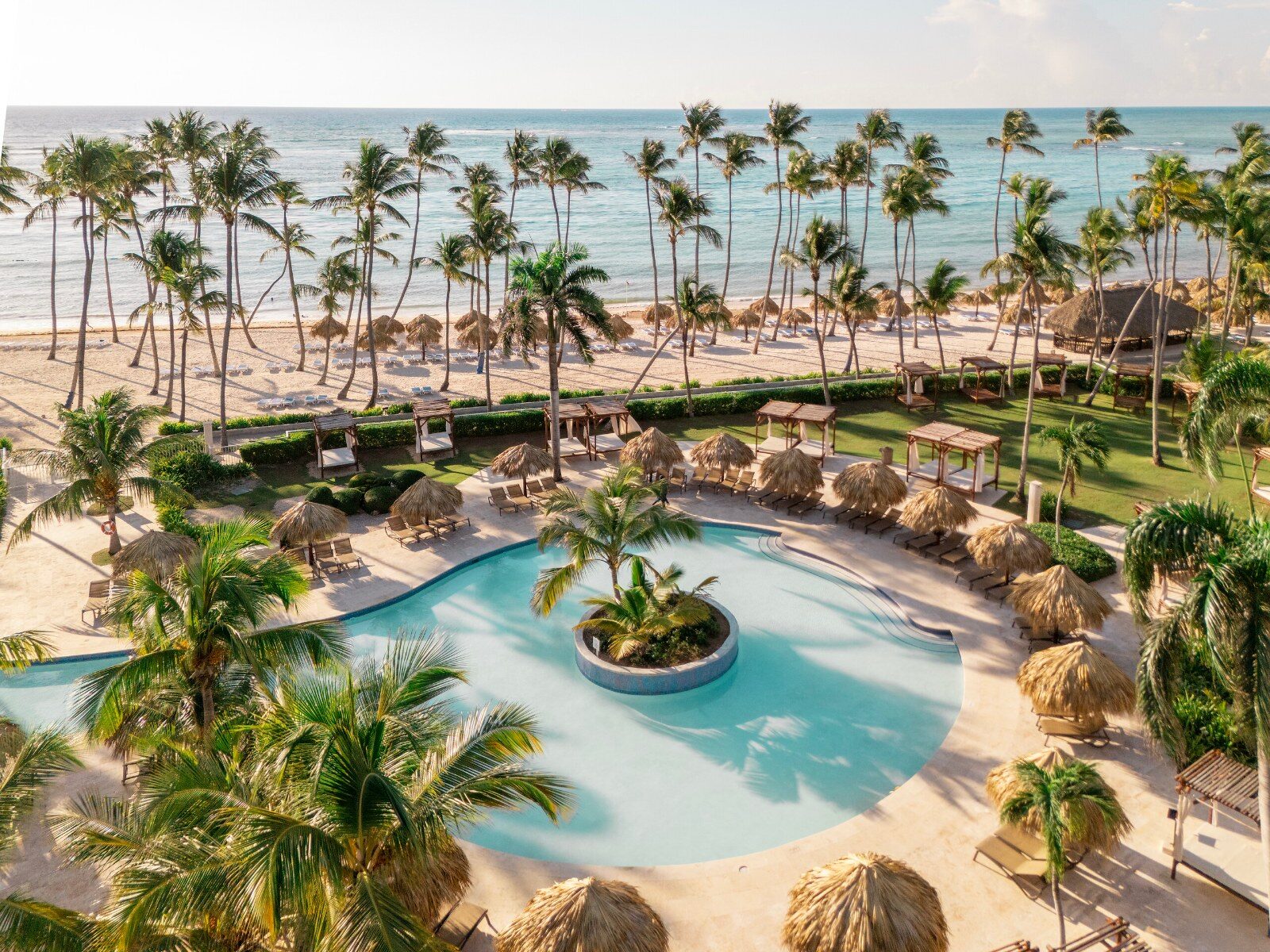 A pool surrounded by palm trees at a Club Med resort in the Caribbean A pool surrounded by palm trees at a Club Med resort in the Caribbean