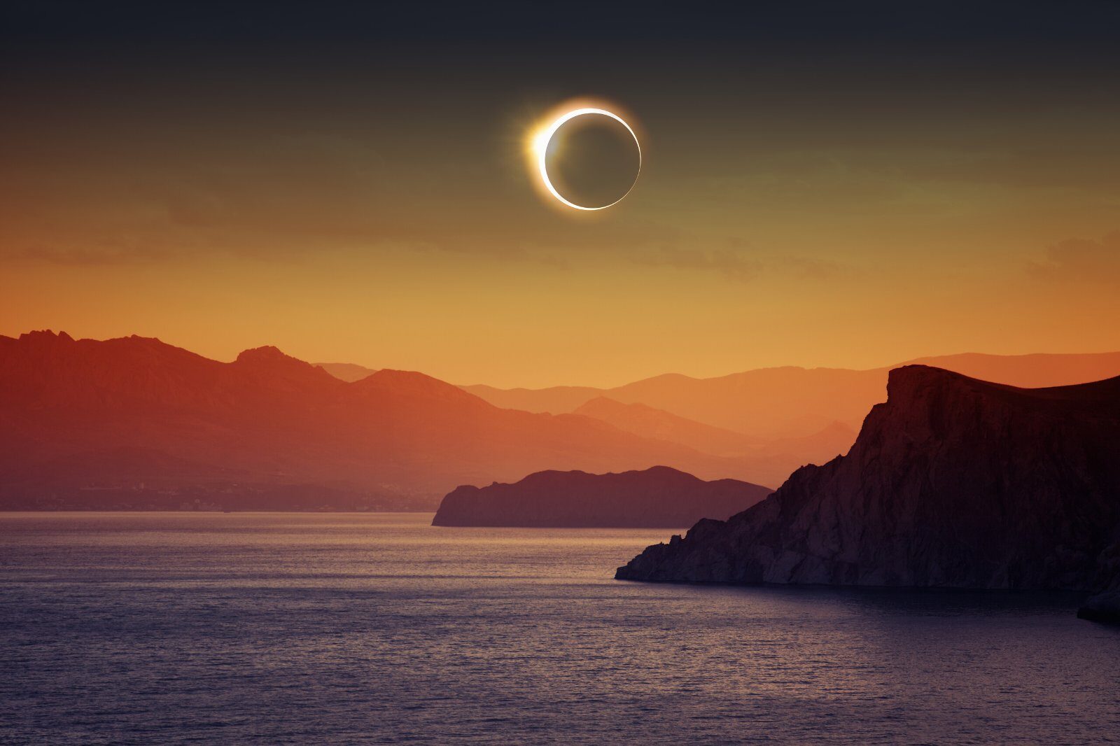 Total solar eclipse above the sea and the cliffs