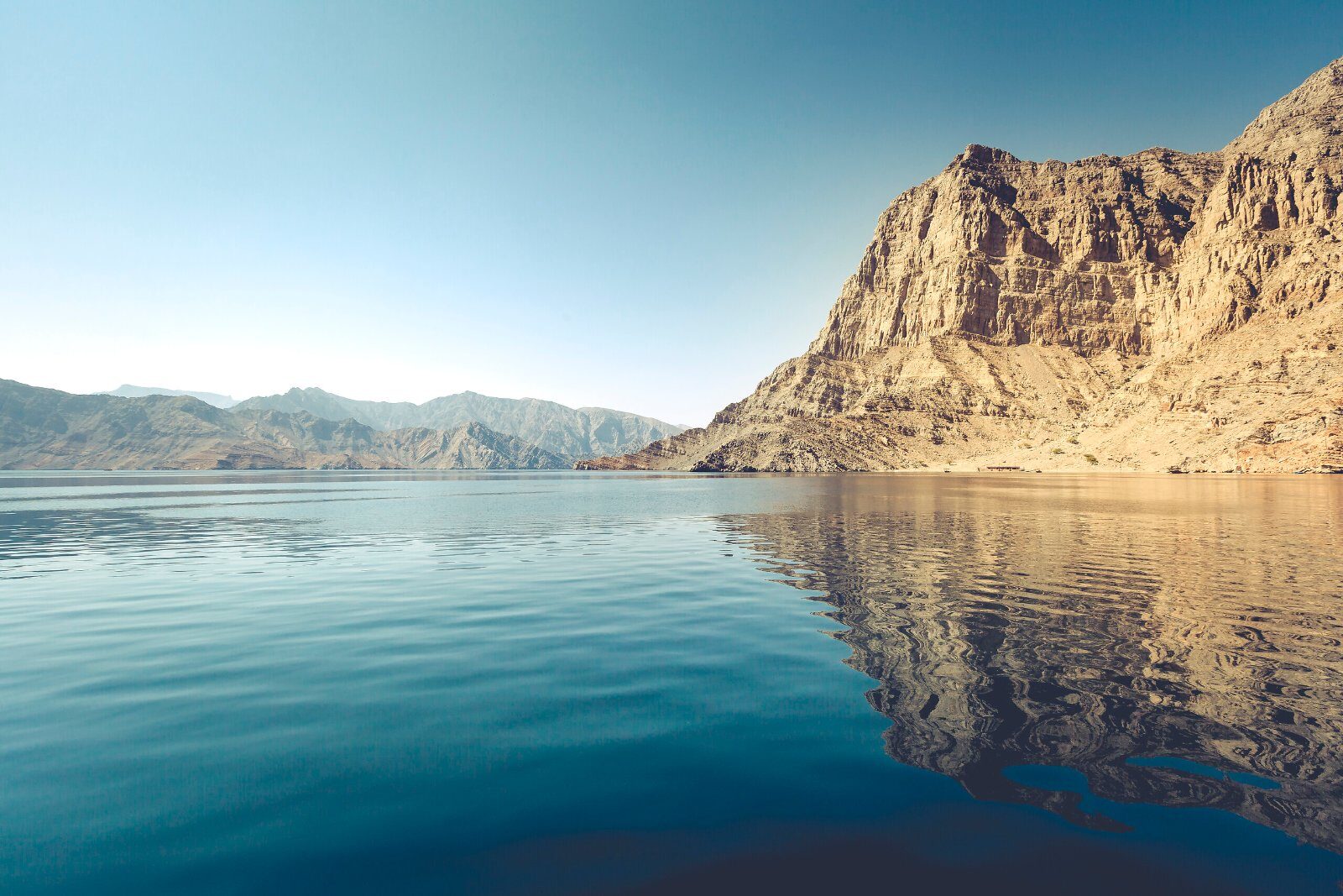 Cliffs and calm water of an Omani fjord