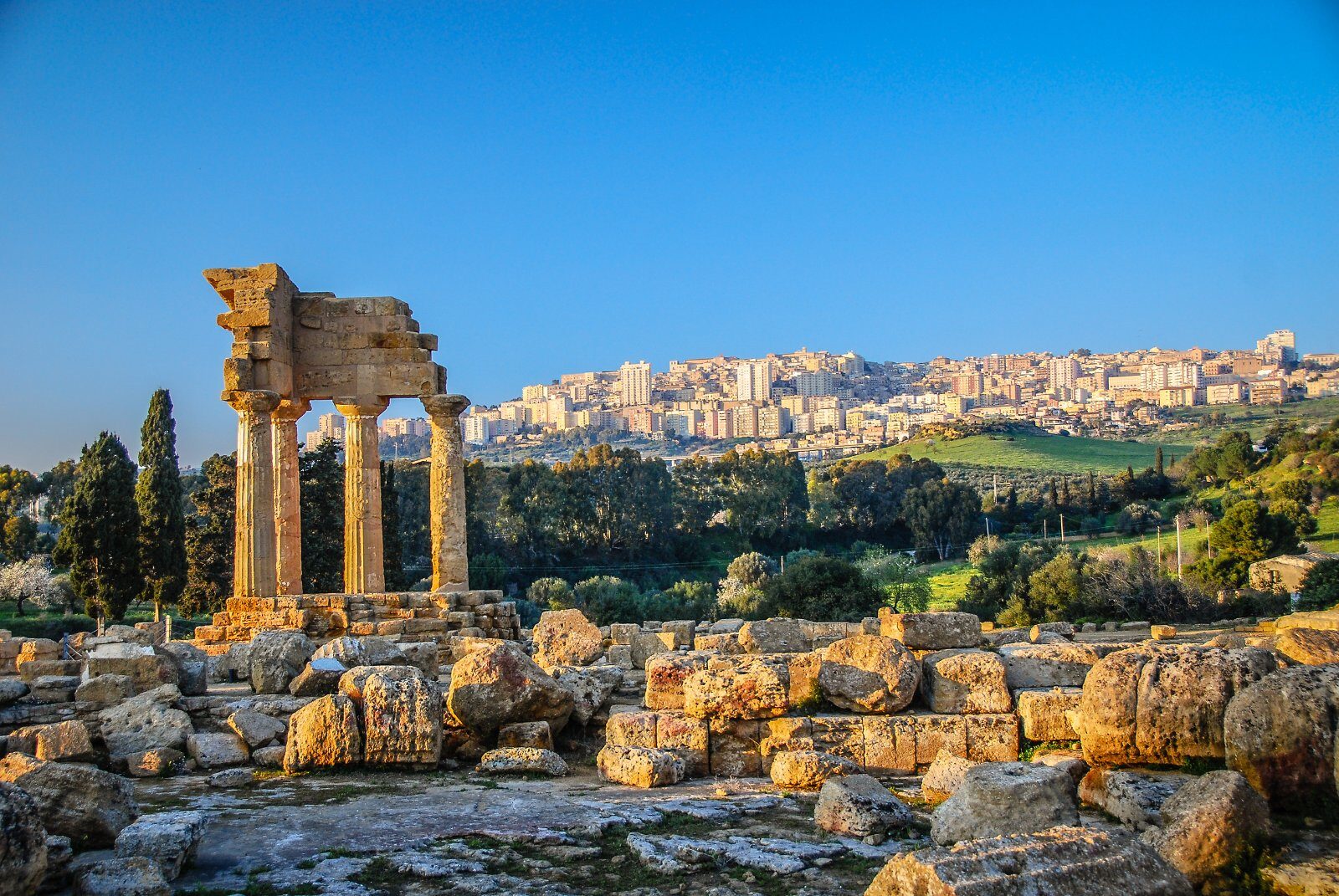 Ruins of a Greek temple above a Sicilian town