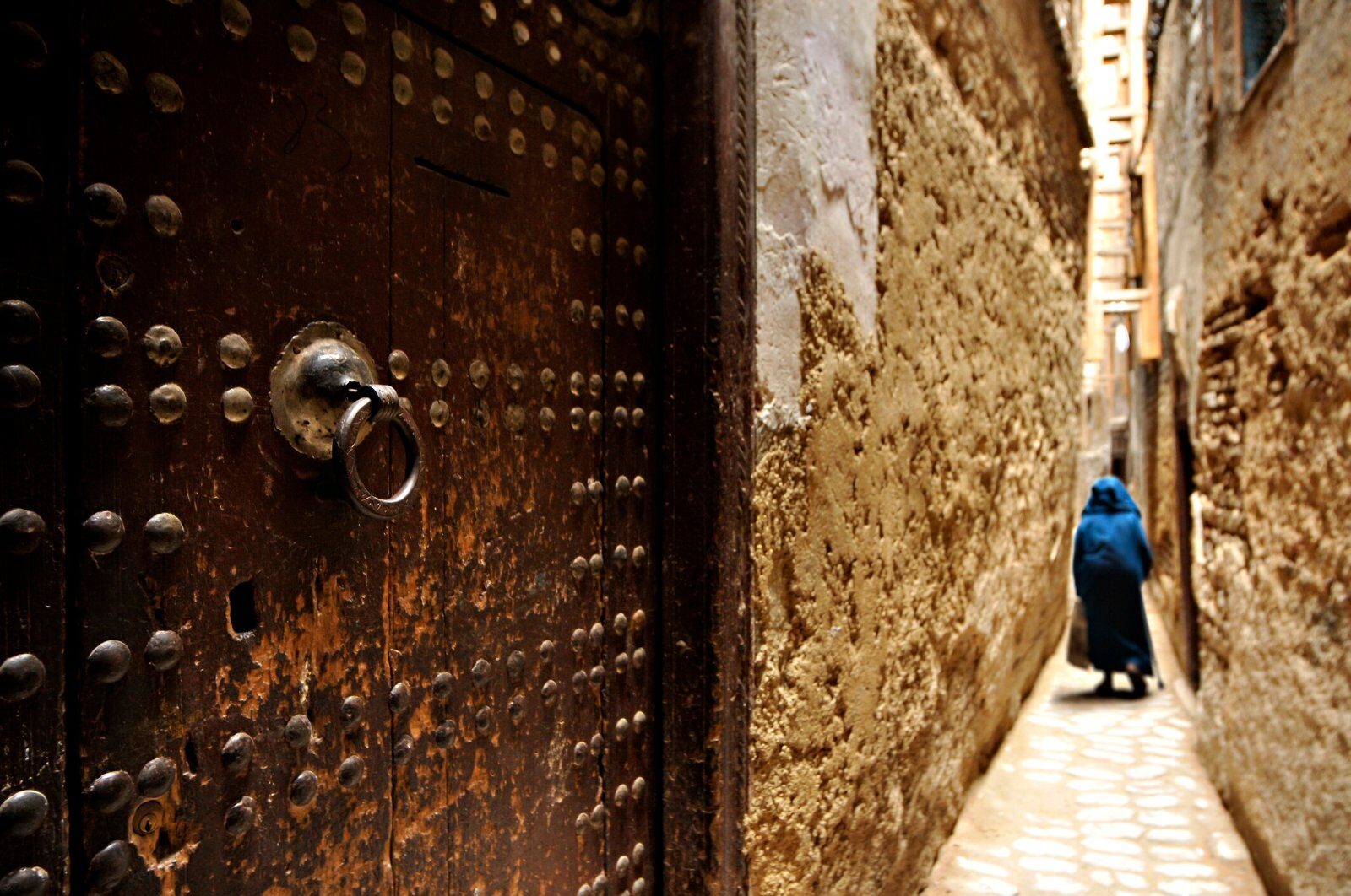 Studded door in a Moroccan medina lane