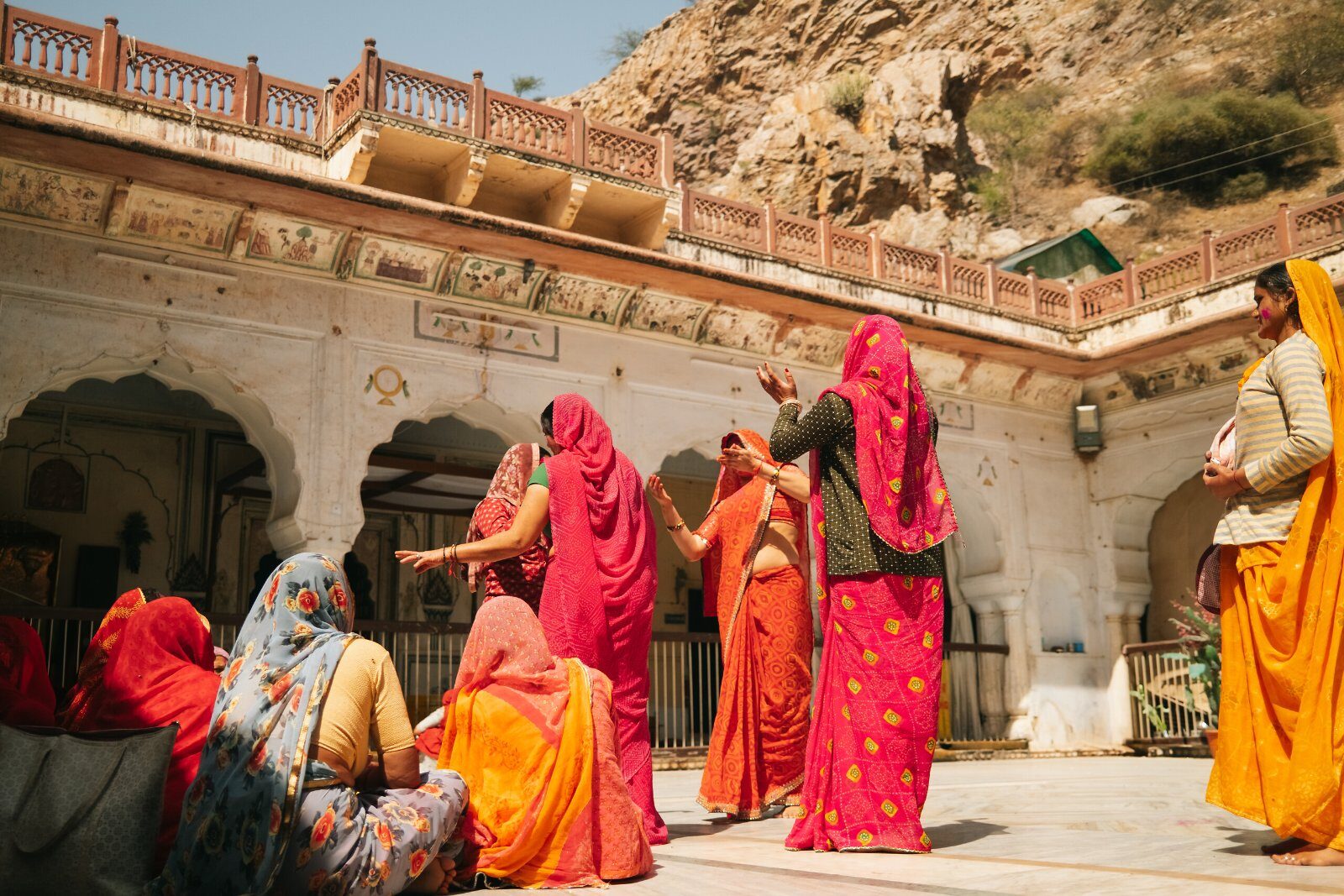 Women in colourful saris in a Rajasthan courtyard
