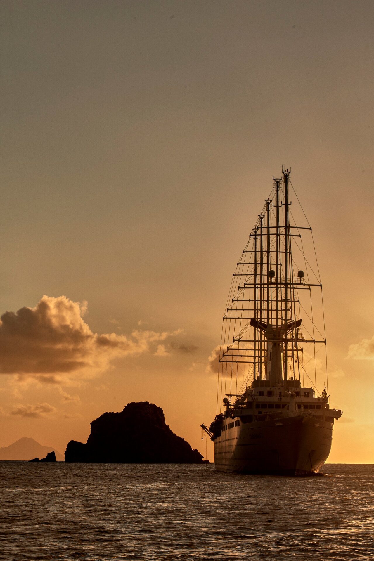 The Club Med 2 under sail at sunset