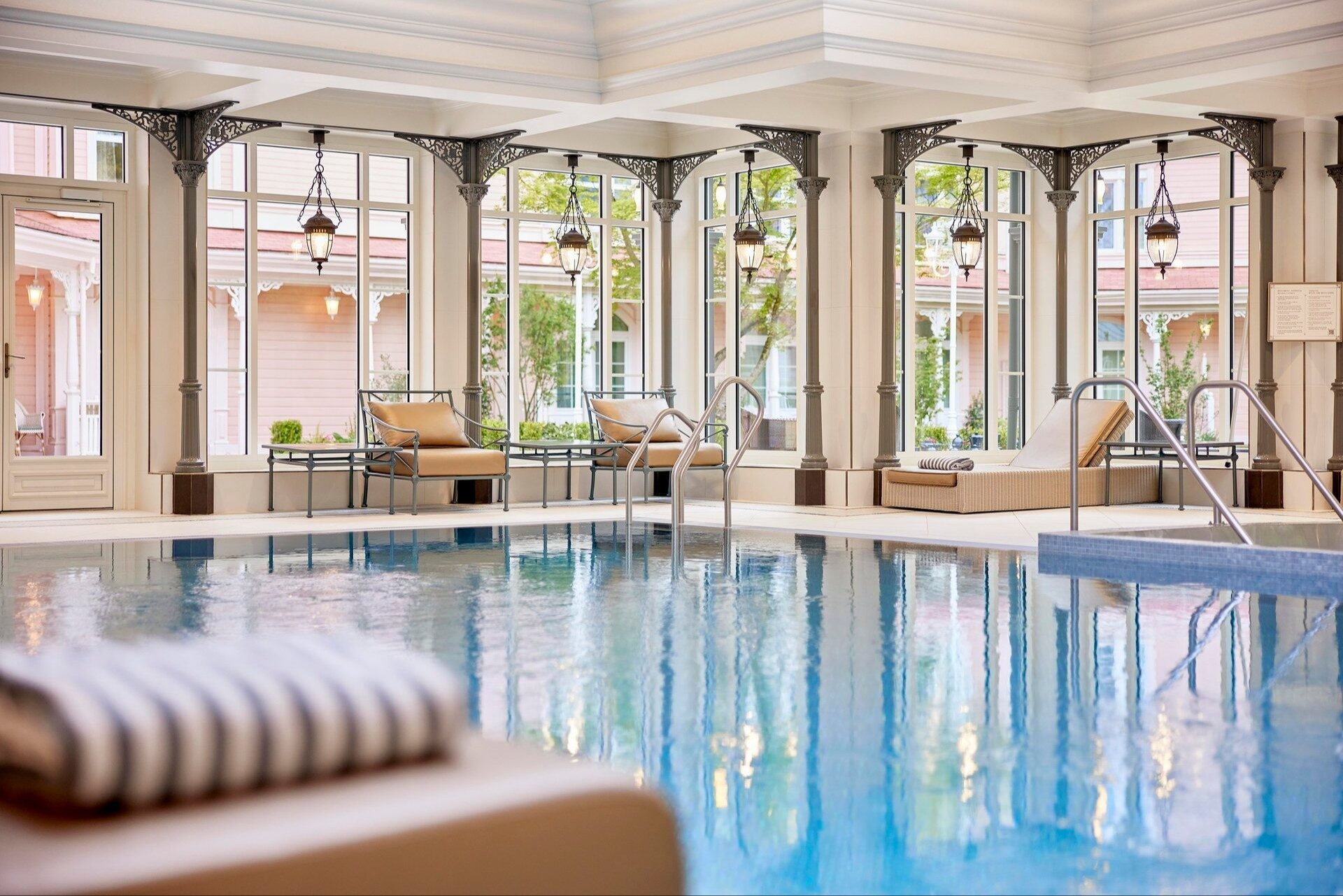 The heated indoor pool of the Crystal Pool at Disneyland Hotel, lined with tall windows framed by iron columns. Photo: ©Disney. The heated indoor pool of the Crystal Pool at Disneyland Hotel, lined with tall windows framed by iron columns. Photo: ©Disney.