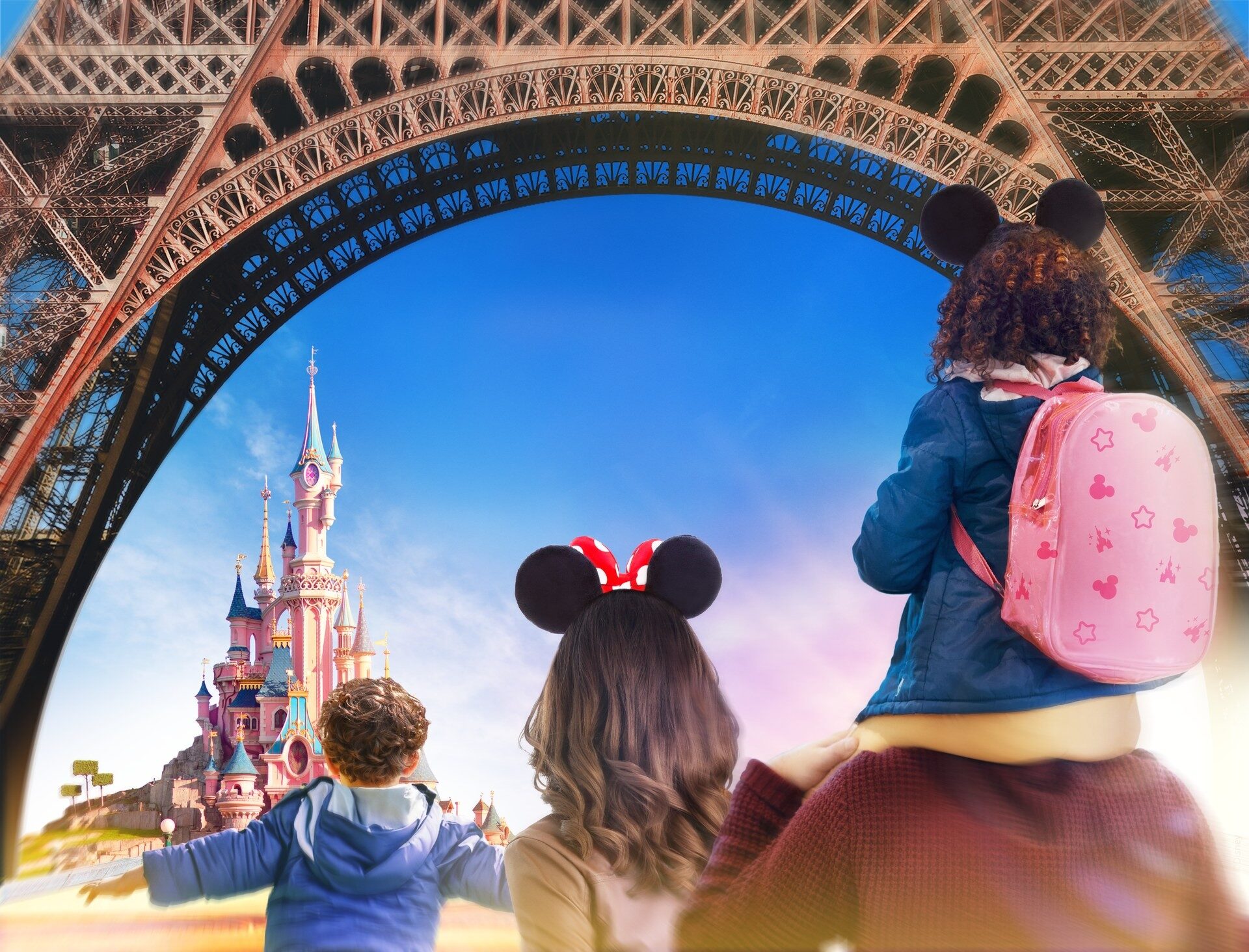 Campaign visual: beneath the arch of the Eiffel Tower, a family gazes at Sleeping Beauty Castle on the horizon. Photo: ©Disney.